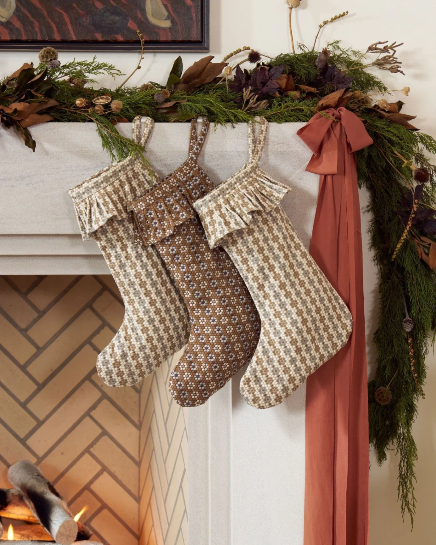 Custom Christmas stockings in Emily Daws Nectar fabric in Raisin, Walnut and Cerulean Blue.